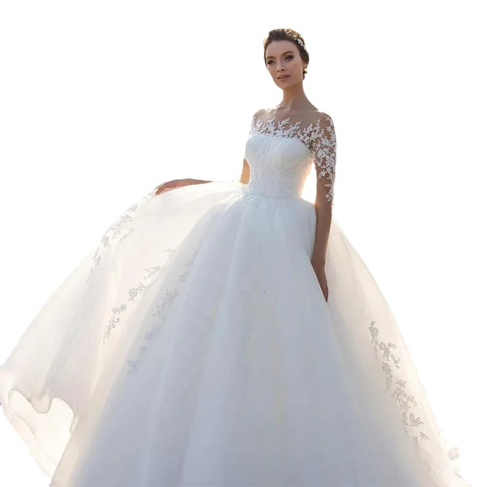 Vestido de novia de malla con mangas largas bordadas